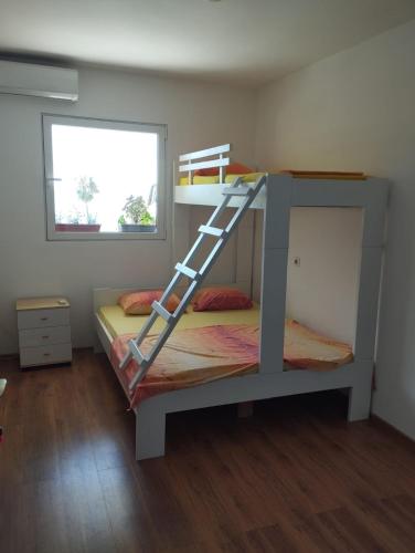 a bunk bed with a ladder in a room at Petrovic house in Herceg-Novi