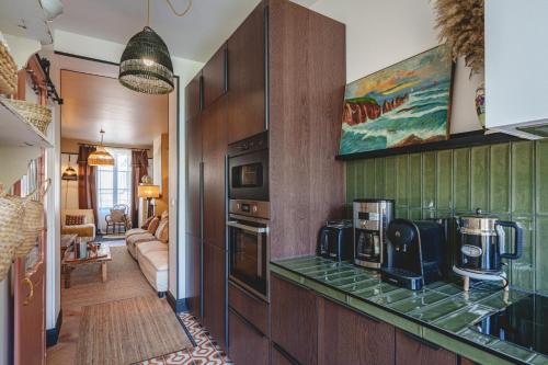 a kitchen with two microwaves on a counter at La Maison D'Ambre - Jacuzzi - Sauna- Clim in Saumur