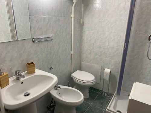 a bathroom with a sink and a toilet and a shower at La casa nel borgo in Monte Sabinese