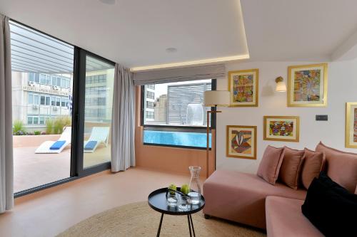 a living room with a couch and a table at Alva Athens Hotel in Athens