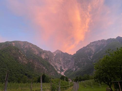 a rainbow in the sky over a mountain range at Agriturismo Pian dei Tass in Barcis
