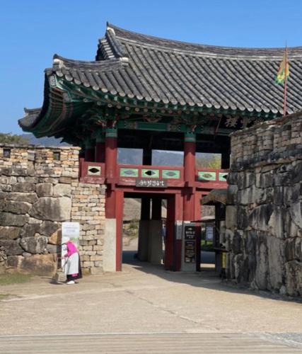 a person standing in front of a building at Naganeupseong Jandi House in Suncheon