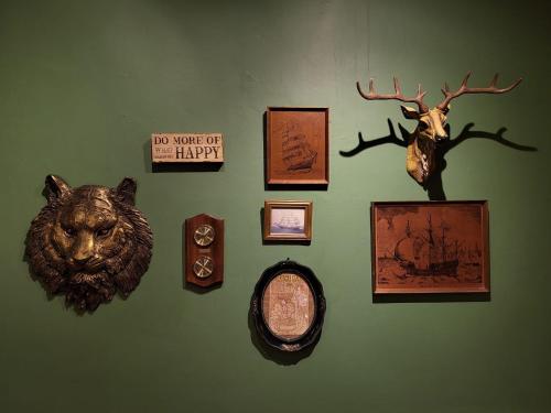 a wall with pictures and a clock on a wall at Casa Encantada Lodge in Baguio