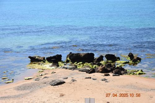 a beach with some rocks and the water at Casa Vacanze Giorgia in Marinella di Selinunte
