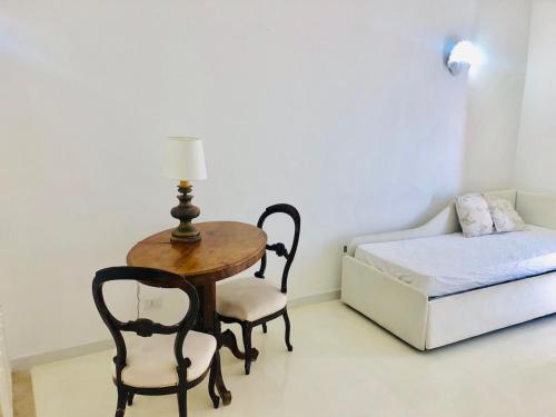 a room with a table and a bed and a table and chair at Filippescha in Positano