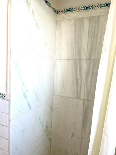 a shower with a shower curtain in a bathroom at Filippescha in Positano