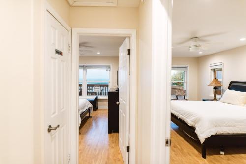 a bedroom with a bed and a view of the ocean at Golden Sands Pearl - Florida's Top - ALL Private Beachfront with NEW Pickleball Court, Pool, Spa in Indialantic