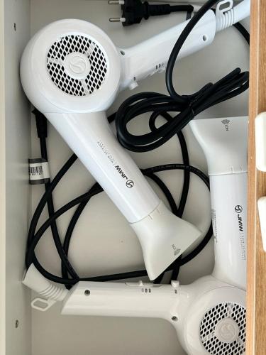 a hair dryer in a drawer with cables at E 2BR 60m2 Newly Built High Floor APT 2min to Hyundai Outlet Triple St 2Free Parking in Incheon
