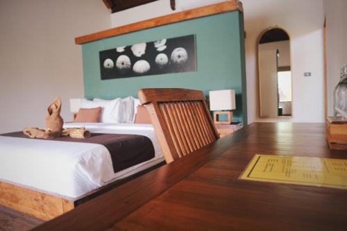 a bedroom with a bed with a teddy bear sitting on it at Dolce Magia in Gili Trawangan