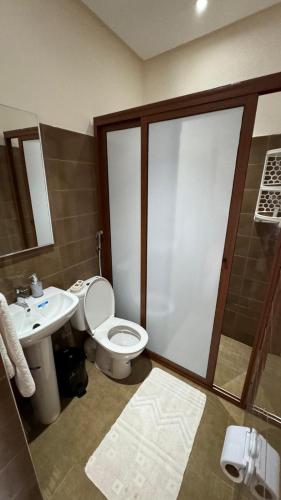 a bathroom with a toilet and a sink and a shower at Eco Farm Tayssir Marrakech in Marrakech