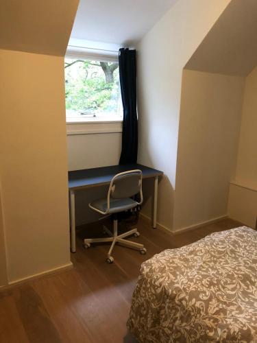 a bedroom with a desk and a chair next to a window at Bright Family Villa on Dune in Wassenaar in Wassenaar