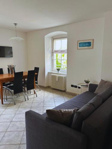 a living room with a couch and a table at Casa nel centro di Cembra in Cembra