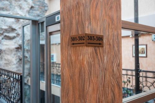 a wooden door with a sign on the side of a building at Hotel Neptun in Vidin