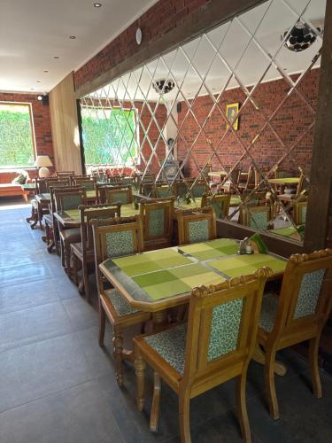 a dining room with wooden tables and chairs at Hotel am Schloss - Frankfurt an der Oder in Frankfurt/Oder