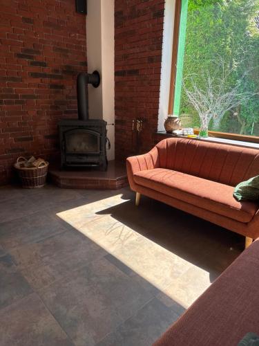 a living room with a couch and a fireplace at Hotel am Schloss - Frankfurt an der Oder in Frankfurt/Oder