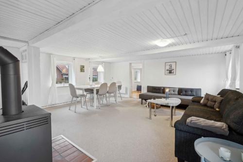 a living room with a couch and a table at Cozy Holiday Home Near Lillebælt in Haderslev