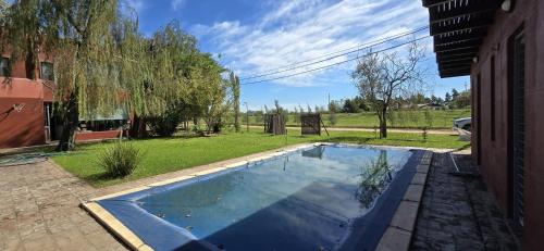 a swimming pool in the backyard of a house at Hotel Ibarlucea in Ybarlucea