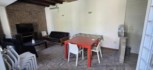 a living room with a red table and chairs at Hotel Ibarlucea in Ybarlucea