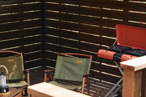 a room with two chairs and a laptop on a desk at Noël Kitakaruizawa Seiryu-2 Riverside retreat in Tsumagoi