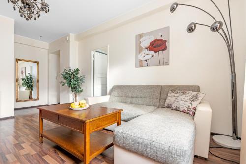 a living room with a couch and a table at Compass apartment in Tallinn