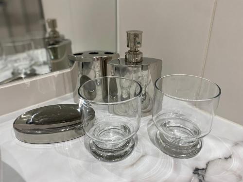two glasses sitting on top of a counter at Compass apartment in Tallinn