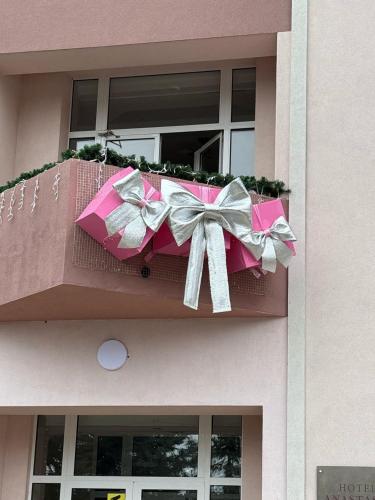 a pink box with a bow on a balcony at Hotel Anastasia in Rezina
