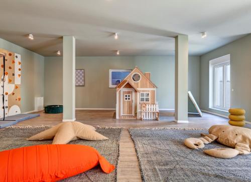 a childs room with a toy house on the floor at Apartment A 1 "Pine Hill Resort" in Zirchow
