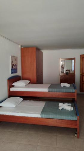 a bedroom with two bunk beds and a mirror at Erasmio Studio in Xanthi