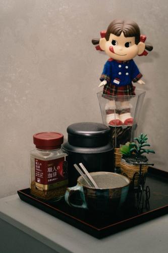 a toy figure of a girl on a shelf with food at 竹の荘 in Nasukarasuyama