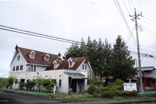 a white house with a brown roof at 竹の荘 in Nasukarasuyama