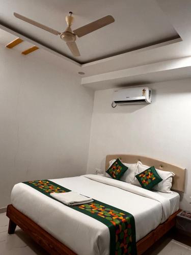 a bedroom with a bed and a ceiling fan at Aaditya Inn Rooms & Banquet hall in Hinjewadi