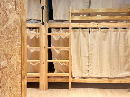 a wooden wardrobe with drawers in a room at Sunset Hostel in Lanyu