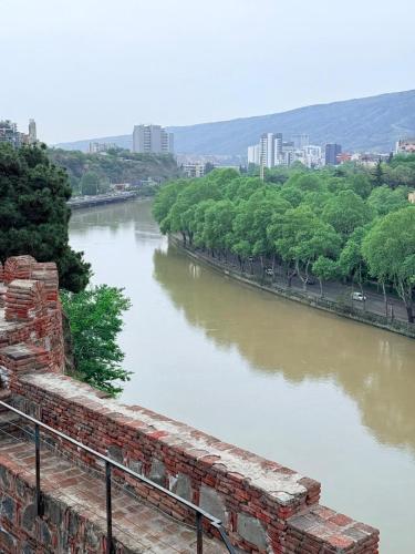 a view of a river from a brick wall at Boutique Hotel Tiflis in Tbilisi City