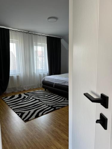 a bedroom with a bed and a zebra print rug at A quiet area in Durleşti