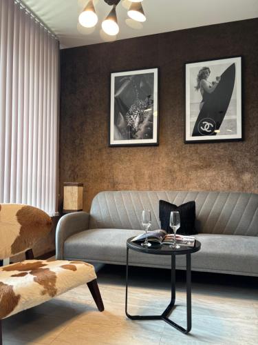 a living room with a couch and a table at Business Park Sofia Cozy Lux & Private Garage Option in Sofia