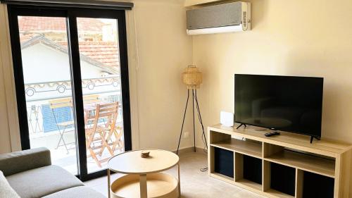 a living room with a flat screen tv and a couch at City Centre 2-Bedroom, Old Town, Nicosia in Nicosia