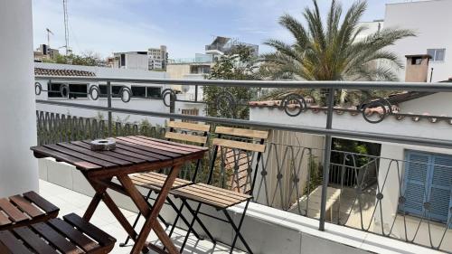 a balcony with a wooden table and two chairs at City Centre 2-Bedroom, Old Town, Nicosia in Nicosia