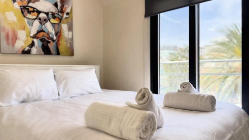 a bedroom with a bed with towels on it at City Centre 2-Bedroom, Old Town, Nicosia in Nicosia