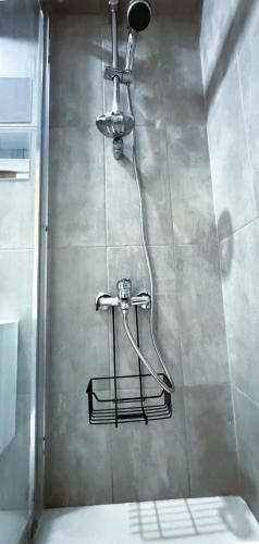 a shower in a bathroom with a shower head at City Centre 2-Bedroom, Old Town, Nicosia in Nicosia
