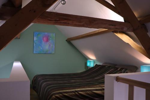 a bedroom with a bed in a attic at Bakhuisje Peer in Peer
