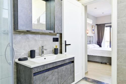 a bathroom with a sink and a bedroom at BENDİS - Villa for 8 People in the center of Fethiye in Fethiye
