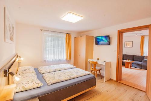 a bedroom with a bed and a living room at Schönes Apartment mit 80qm in Senales