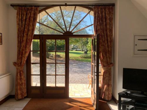 an open door with a view of a yard at Beautiful Big Home with Swimming Pool and Nature Grounds in Auterrive