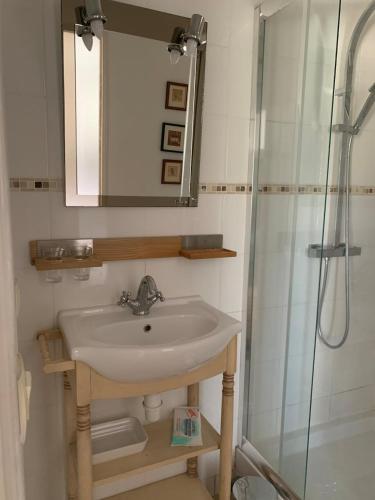 a bathroom with a sink and a shower at Beautiful Big Home with Swimming Pool and Nature Grounds in Auterrive