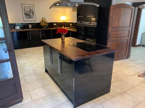 a kitchen with a island with a counter top at Beautiful Big Home with Swimming Pool and Nature Grounds in Auterrive