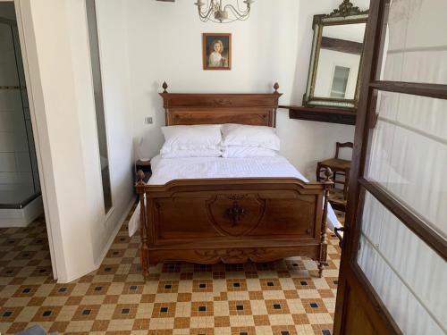 a bedroom with a wooden bed with a mirror at Beautiful Big Home with Swimming Pool and Nature Grounds in Auterrive