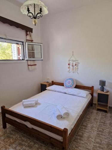 a bedroom with a bed with towels on it at ANiko in Kolymbia