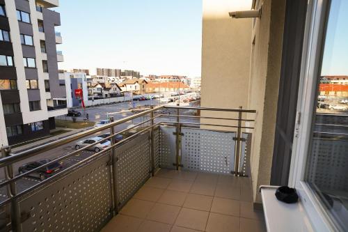 a balcony with a view of a city at Mirandis Apartments - Modern Stays with Free Parking near Coresi Mall in Braşov