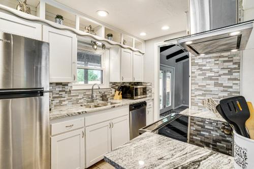 a kitchen with white cabinets and stainless steel appliances at 2 Mi to Lake Home with Game Room, Pool and Fast WiFi! in Wichita Falls