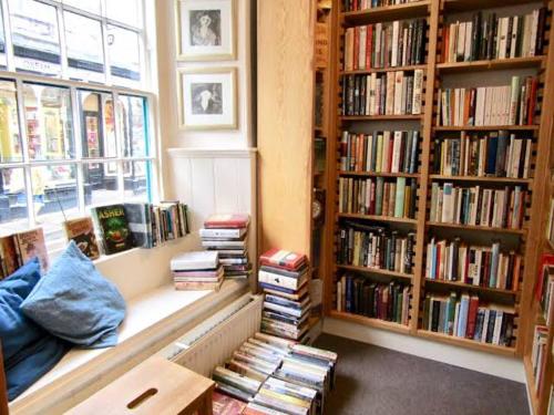 a room with book shelves filled with books at Hay On Wye Welsh Townhouse in Hay centre in Hay-on-Wye